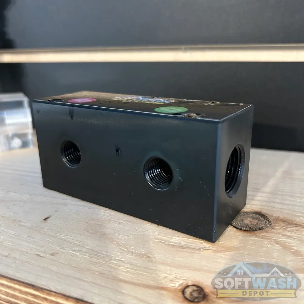 Black downstream injector manifold block available in 2-port and 3-port configurations, featuring chemical-resistant valves and barbed fittings for quick soft wash solution switching. - Soft Wash Depot