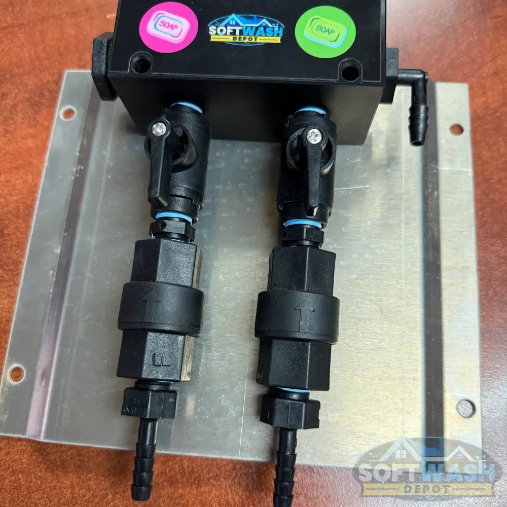 Black downstream injector manifold block available in 2-port and 3-port configurations, featuring chemical-resistant valves and barbed fittings for quick soft wash solution switching. - Soft Wash Depot