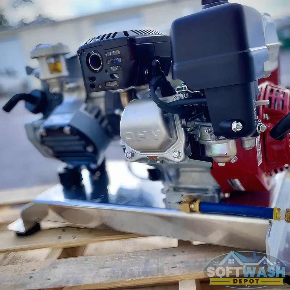 Honda engine with Comet P40 softwash pump system mounted on aluminum base, featuring battery cables and chemical-resistant components - Soft Wash Depot.