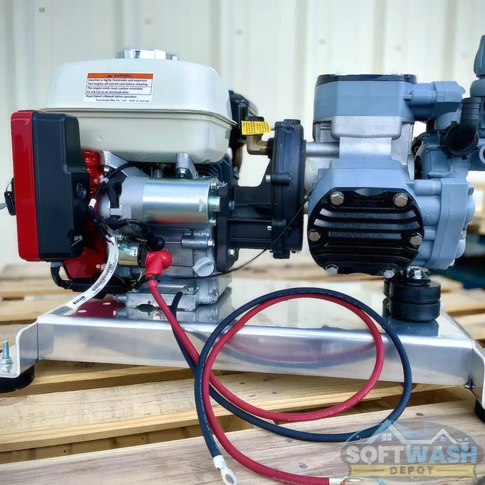 Honda engine with Comet P40 softwash pump system mounted on aluminum base, featuring battery cables and chemical-resistant components - Soft Wash Depot.