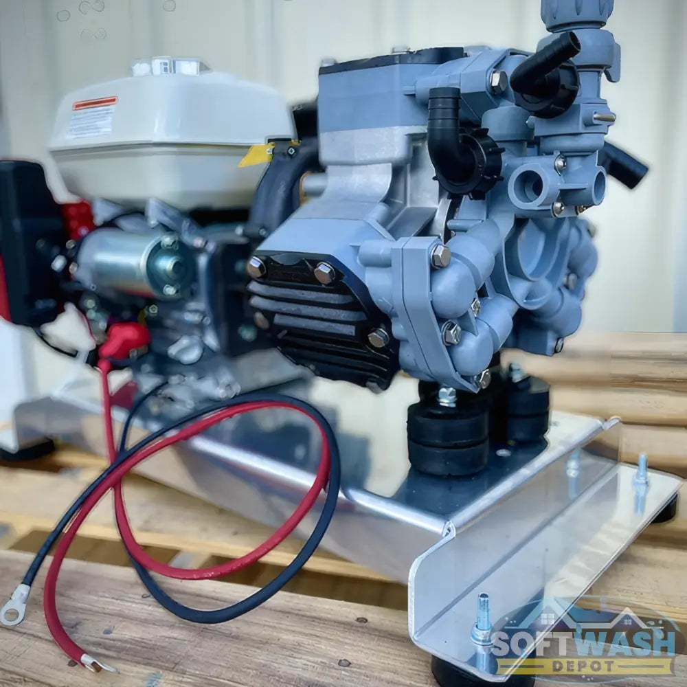 Honda engine with Comet P40 softwash pump system mounted on aluminum base, featuring battery cables and chemical-resistant components - Soft Wash Depot.