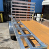 2026 Alcom 6x12 single axle aluminum trailer with rear drop-down tailgate and pressure-treated wood floor, designed for contractor and soft wash equipment setups. - Soft Wash Depot