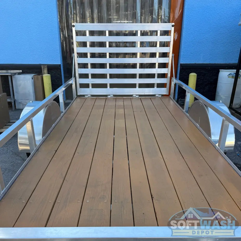 2026 Alcom 6x12 single axle aluminum trailer with rear drop-down tailgate and pressure-treated wood floor, designed for contractor and soft wash equipment setups. - Soft Wash Depot